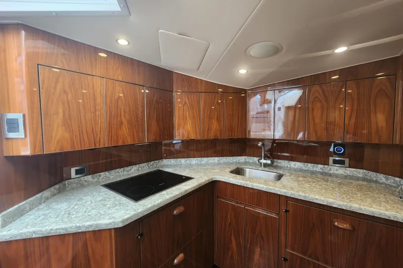 Slide: The Image of Luxurious kitchen interior of 2018 Viking 48 Sport Tower yacht with wood cabinetry and modern appliances. - 53