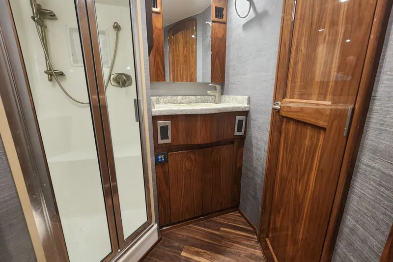 Slide: The Image of Luxurious bathroom in 2018 Viking 48 Sport Tower yacht with wood accents and modern fixtures. - 65