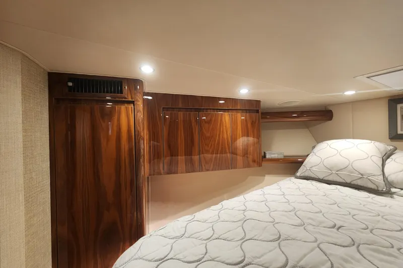 Slide: The Image of Luxurious cabin interior of 2018 Viking 48 Sport Tower yacht with wood paneling. - 69