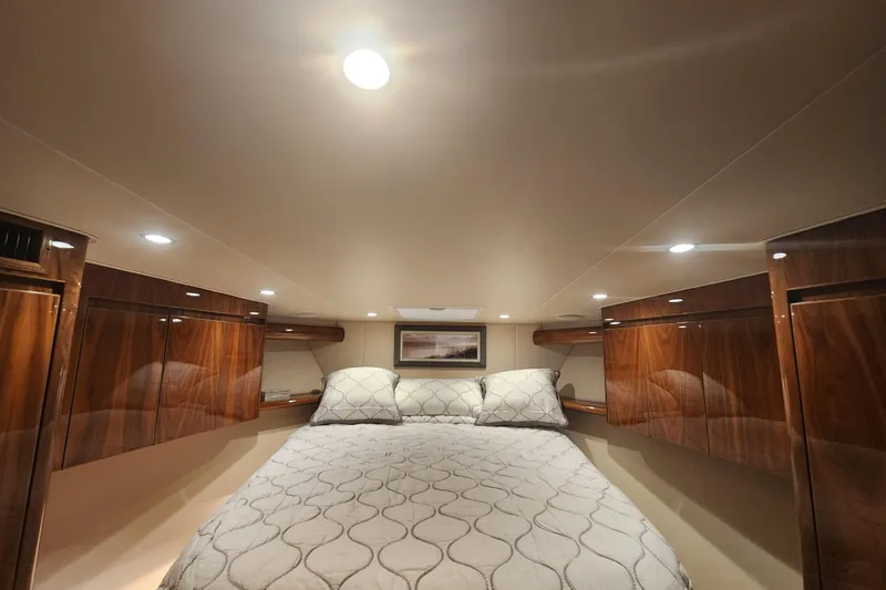 Slide: The Image of Luxurious cabin interior of 2018 Viking 48 Sport Tower yacht with elegant wood finishes. - 70