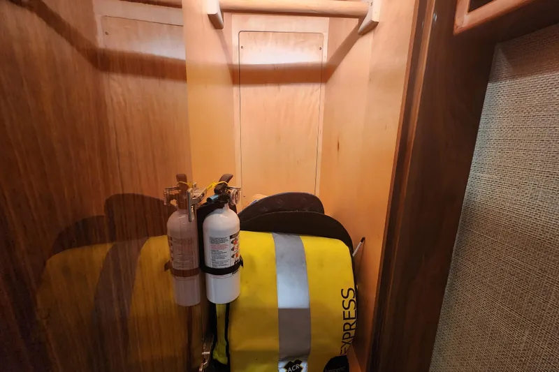 Slide: The Image of Storage compartment in 2018 Viking 48 Sport Tower with safety equipment. - 73