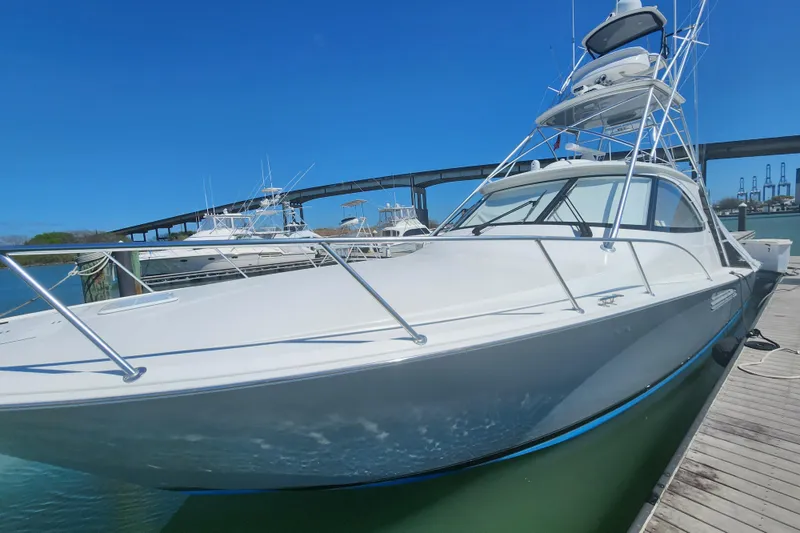 Slide: The Image of 2018 Viking 48 Sport Tower yacht docked under clear blue sky. - 8