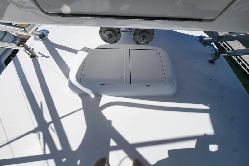 Slide: The Image of 2018 Viking 48 Sport Tower deck with hatch and railing shadows. - 82