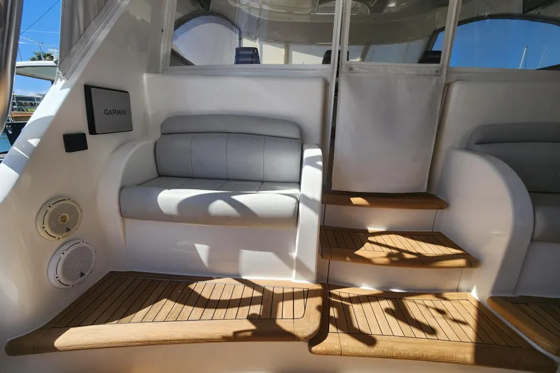 Slide: The Image of 2018 Viking 48 Sport Tower interior with cushioned seating and wooden steps. - 86