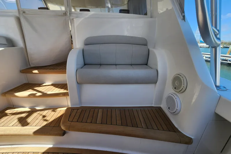 Slide: The Image of 2018 Viking 48 Sport Tower interior with wooden steps and cushioned seating. - 87