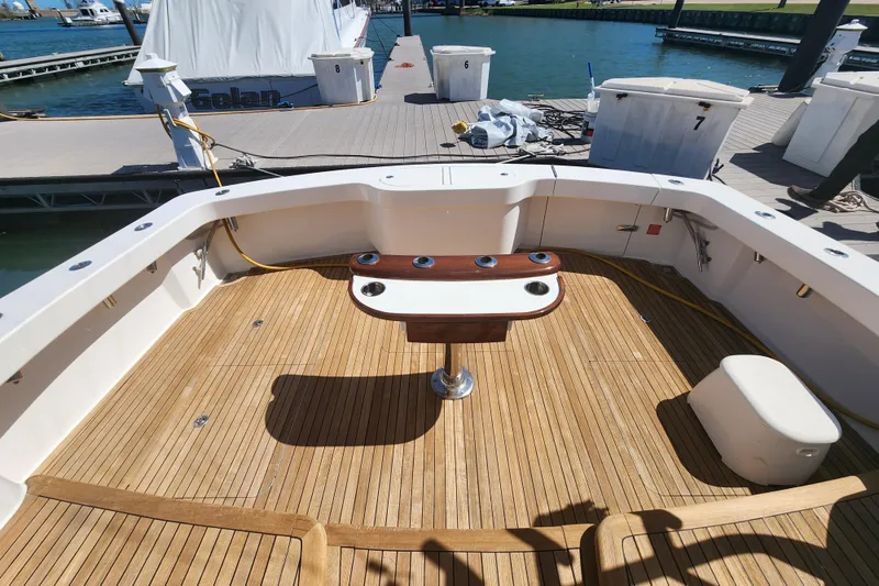 Slide: The Image of 2018 Viking 48 Sport Tower yacht deck with wooden flooring and fishing station. - 90