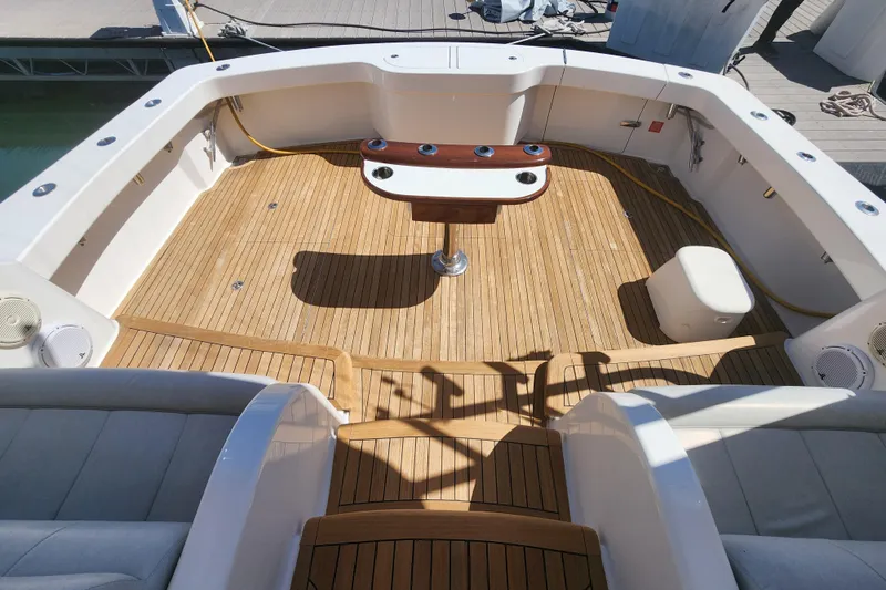 Slide: The Image of Cockpit of 2018 Viking 48 Sport Tower with teak flooring and fishing station. - 91