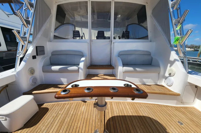 Slide: The Image of 2018 Viking 48 Sport Tower yacht interior with seating and wooden deck. - 93