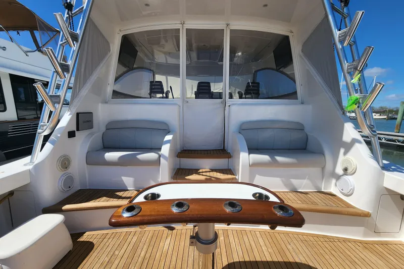 Slide: The Image of 2018 Viking 48 Sport Tower yacht interior with seating and wooden deck. - 95
