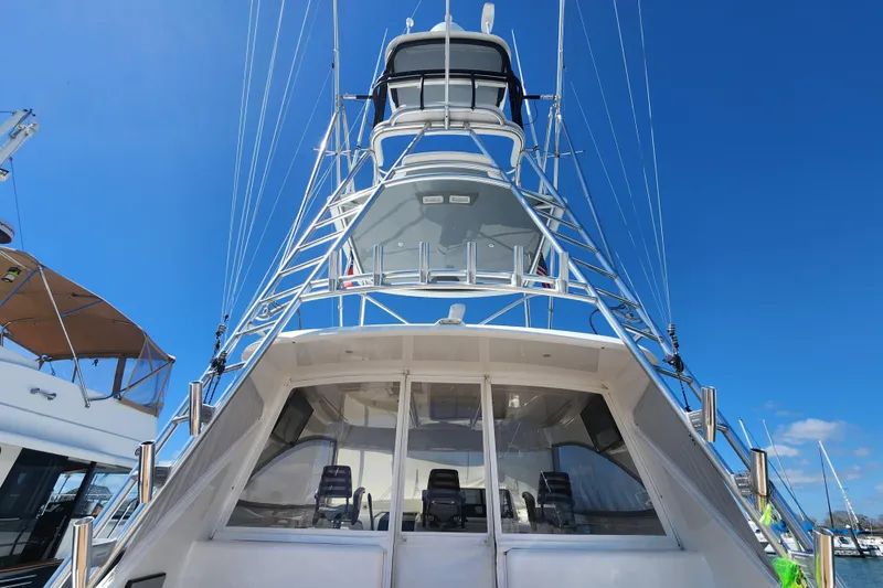 Slide: The Image of 2018 Viking 48 Sport Tower yacht with sleek design against clear blue sky. - 97