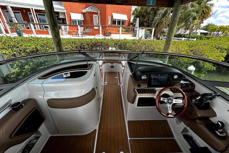 Slide: The Image of 2017 Crownline Eclipse E29 XS boat interior with modern dashboard and wood accents. - 11
