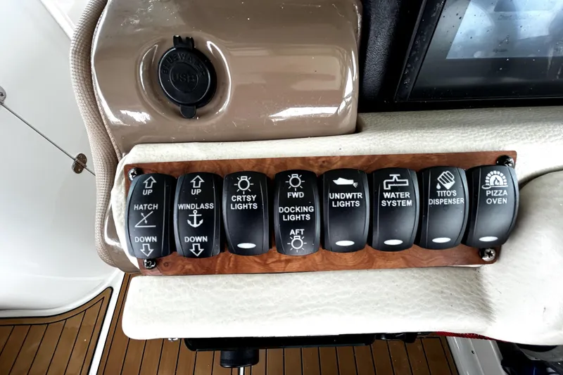 Slide: The Image of Control panel of a 2017 Crownline Eclipse E29 XS boat with labeled switches. - 16