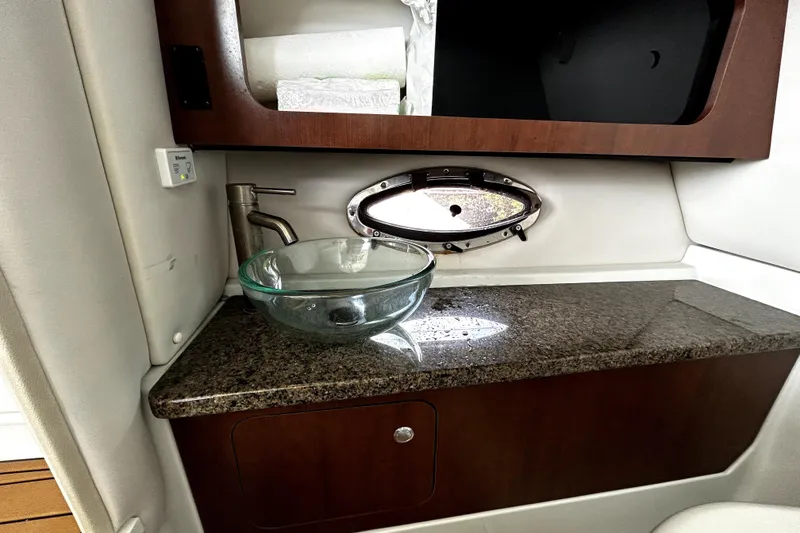 Slide: The Image of 2017 Crownline Eclipse E29 XS boat interior with glass sink and granite countertop. - 21