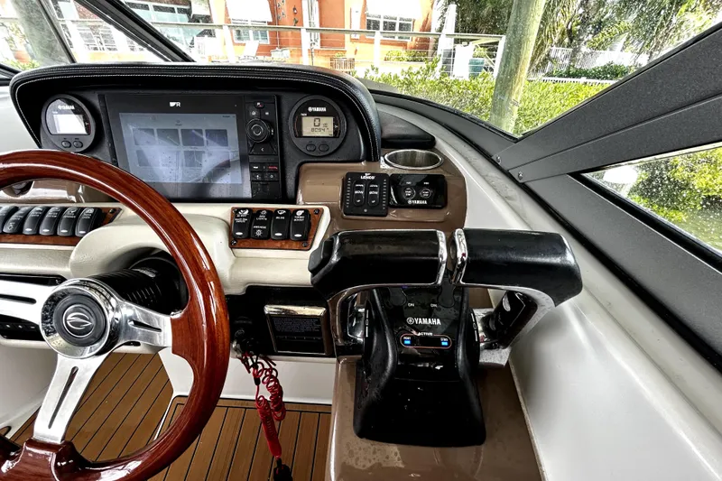 Slide: The Image of 2017 Crownline Eclipse E29 XS boat dashboard with steering wheel and navigation controls. - 26