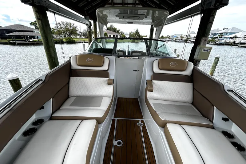 Slide: The Image of 2017 Crownline Eclipse E29 XS boat interior with luxurious seating and waterfront view. - 36