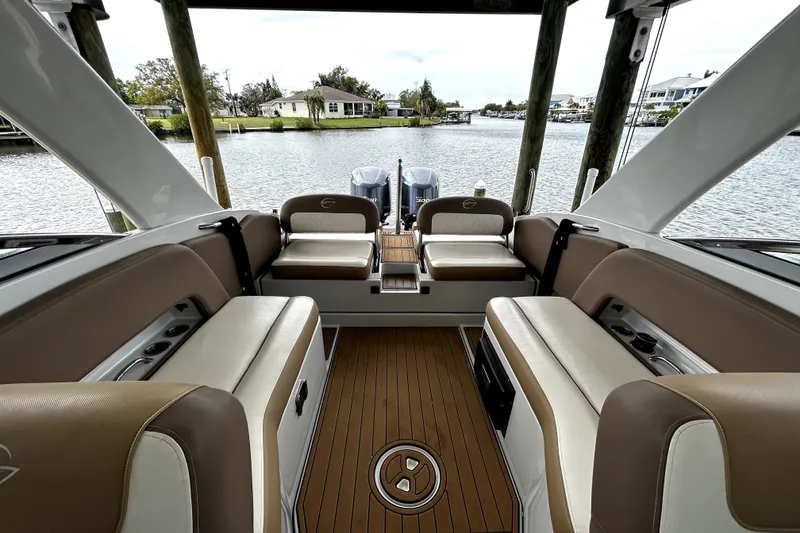 Slide: The Image of 2017 Crownline Eclipse E29 XS boat interior with tan seating and wood flooring. - 39