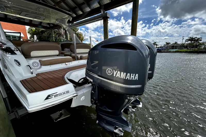 Slide: The Image of 2017 Crownline Eclipse E29 XS boat with Yamaha outboard engines docked by the water. - 4