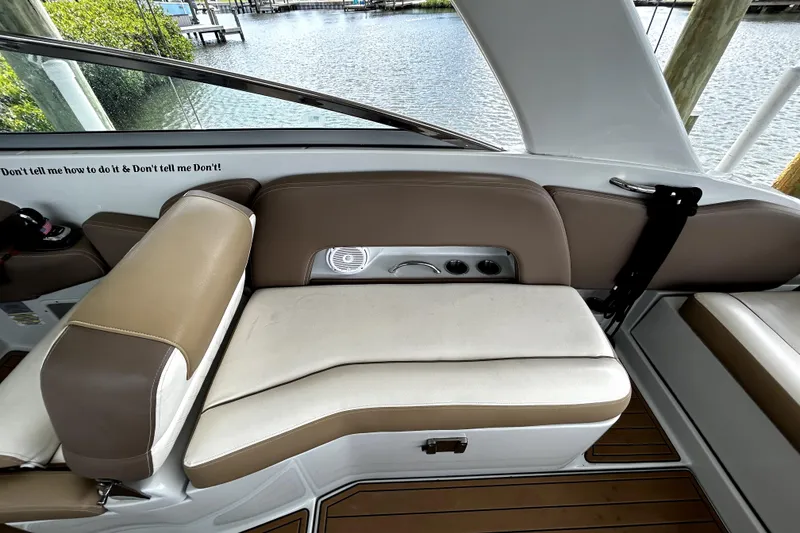 Slide: The Image of 2017 Crownline Eclipse E29 XS boat interior with tan seating and scenic water view. - 43
