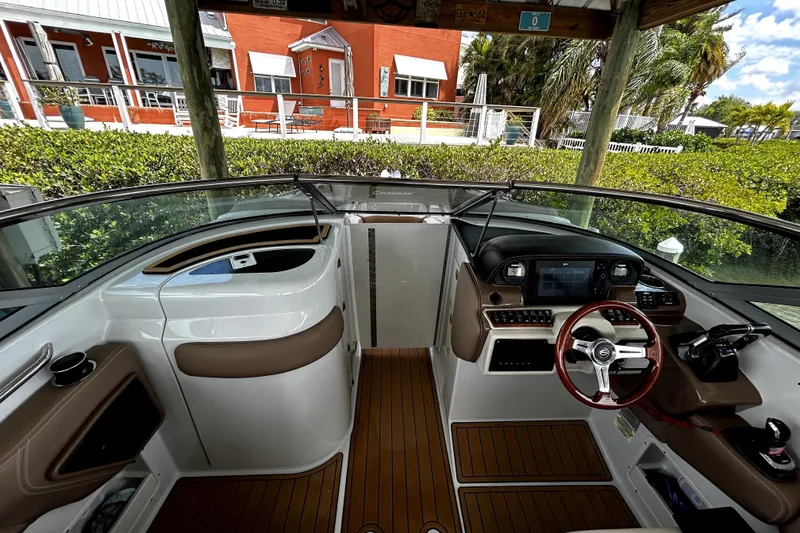 Slide: The Image of 2017 Crownline Eclipse E29 XS boat cockpit with modern controls and wood accents. - 47