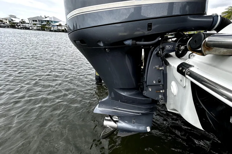 Slide: The Image of Outboard motor of 2017 Crownline Eclipse E29 XS on water, showcasing engine details. - 52