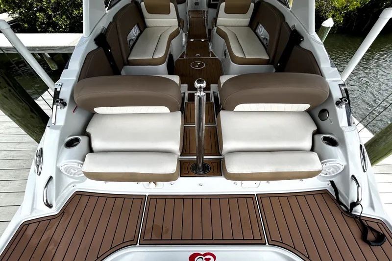 Slide: The Image of 2017 Crownline Eclipse E29 XS boat interior with cushioned seating and wood-style flooring. - 55
