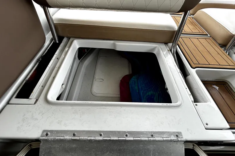 Slide: The Image of 2017 Crownline Eclipse E29 XS boat storage compartment with cushioned seating and teak flooring. - 57