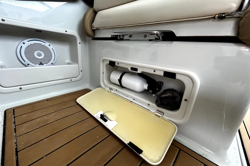 Slide: The Image of 2017 Crownline Eclipse E29 XS boat storage compartment with fire extinguisher and speaker. - 61