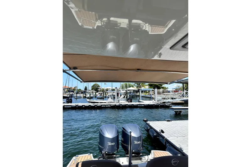Slide: The Image of 2017 Crownline Eclipse E29 XS boat with dual 300 horsepower engines at a marina dock. - 66