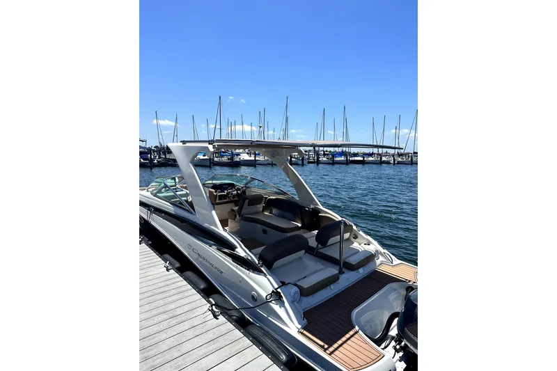 Slide: The Image of 2017 Crownline Eclipse E29 XS boat docked at marina, clear blue sky. - 68