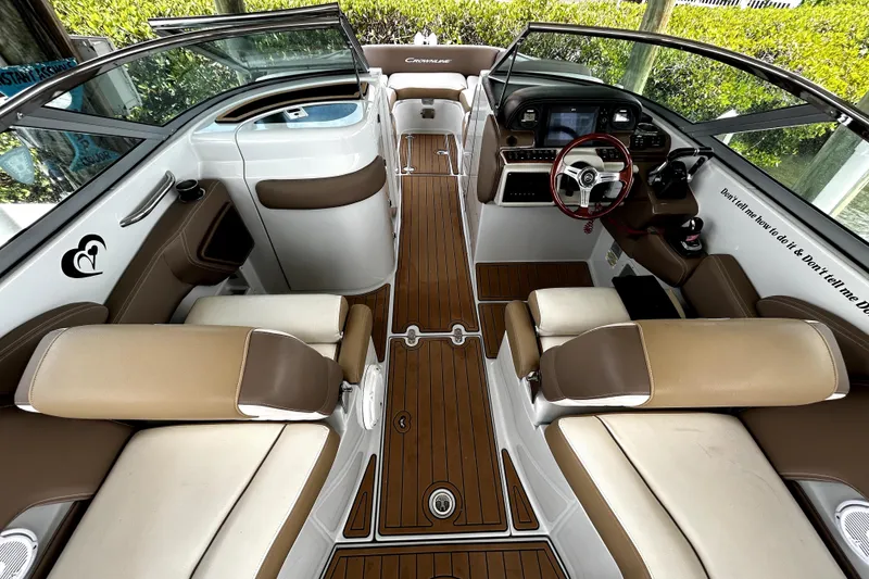Slide: The Image of Luxurious interior of 2017 Crownline Eclipse E29 XS boat with tan seating and wood flooring. - 9