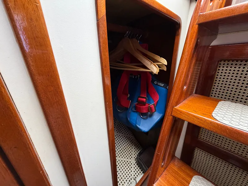 Slide: The Image of Wooden closet with hangers and safety gear on Benford 39, 1985 model. - 21