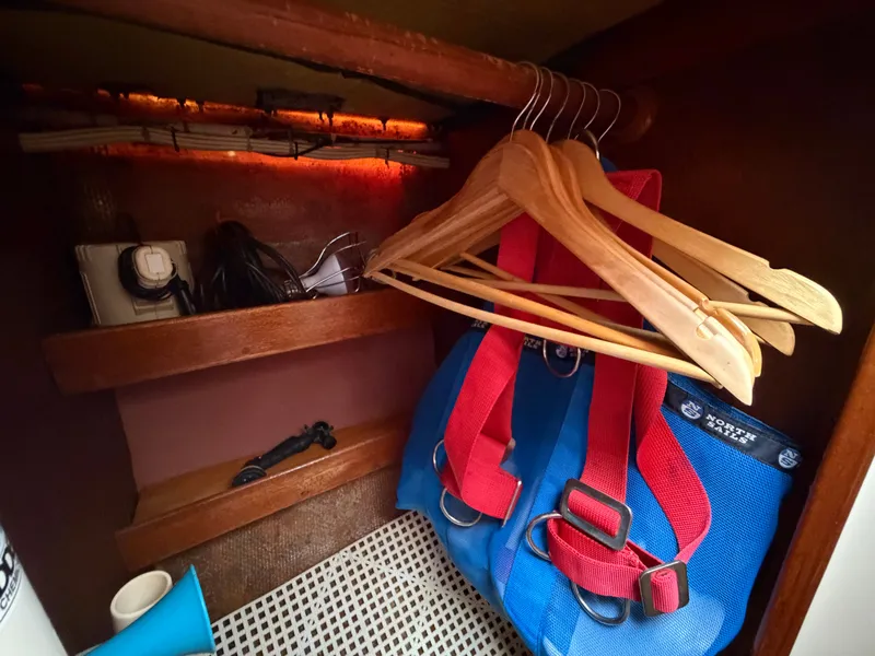 Slide: The Image of Cabinet in Benford 39 boat with hangers and sailing gear. - 23