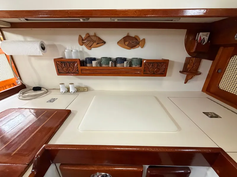 Slide: The Image of Galley area of a 1985 Benford 39 yacht with wooden shelves. - 43