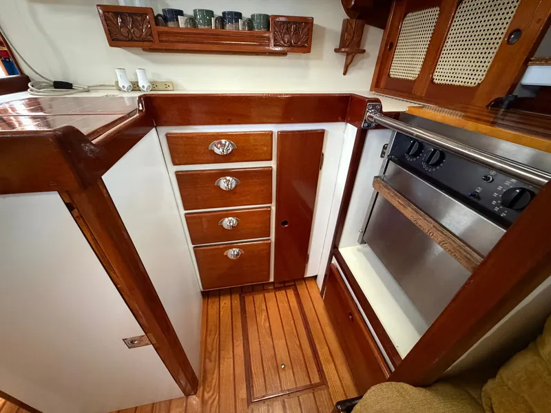 Slide: The Image of 1985 Benford 39 yacht kitchen area with wooden cabinets. - 44