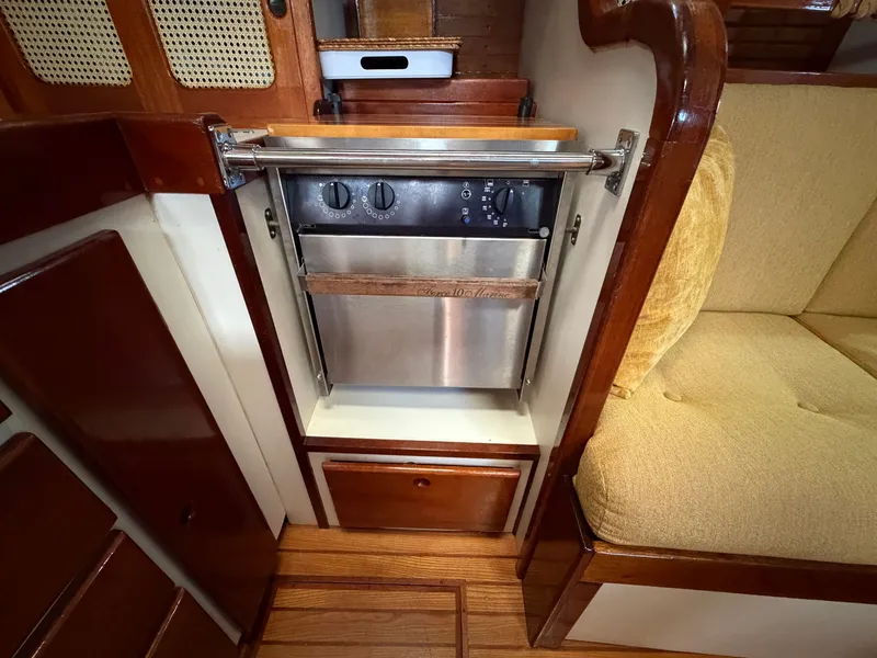 Slide: The Image of Compact kitchen in 1985 Benford 39 yacht with wood paneling. - 45