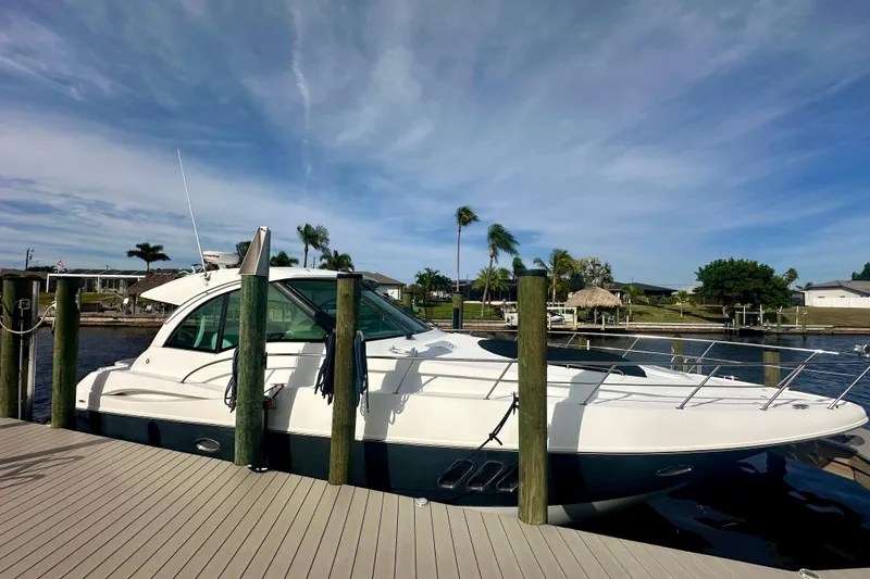 The Image of 2011 Cruisers Yachts 420 Sports Coupe docked by a scenic waterfront. - 1