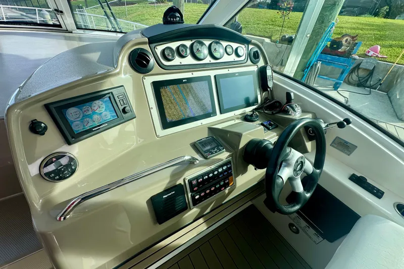 Slide: The Image of Helm of 2011 Cruisers Yachts 420 Sports Coupe with advanced navigation controls and displays. - 10