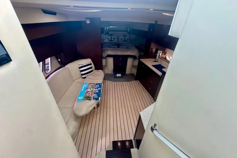 Slide: The Image of Interior of 2011 Cruisers Yachts 420 Sports Coupe, featuring cozy seating and modern amenities. - 14