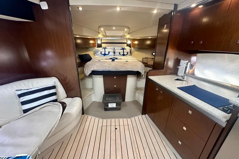 Slide: The Image of Luxurious interior of 2011 Cruisers Yachts 420 Sports Coupe with cozy bed and modern kitchenette. - 16