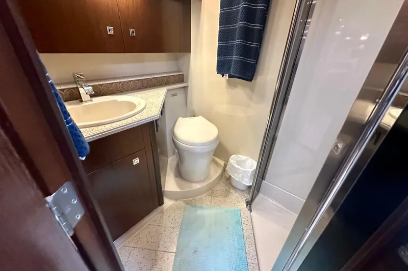 Slide: The Image of 2011 Cruisers Yachts 420 Sports Coupe bathroom with sink, toilet, and shower. - 18