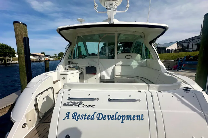 Slide: The Image of 2011 Cruisers Yachts 420 Sports Coupe docked, featuring spacious seating and sleek design. - 5