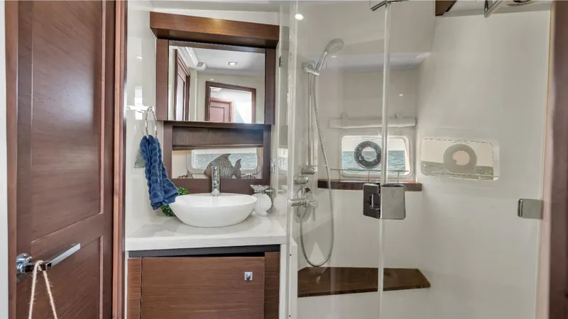 Slide: The Image of Luxurious bathroom in 2015 Sea Ray 510 Fly yacht with modern fixtures and wooden accents. - 14