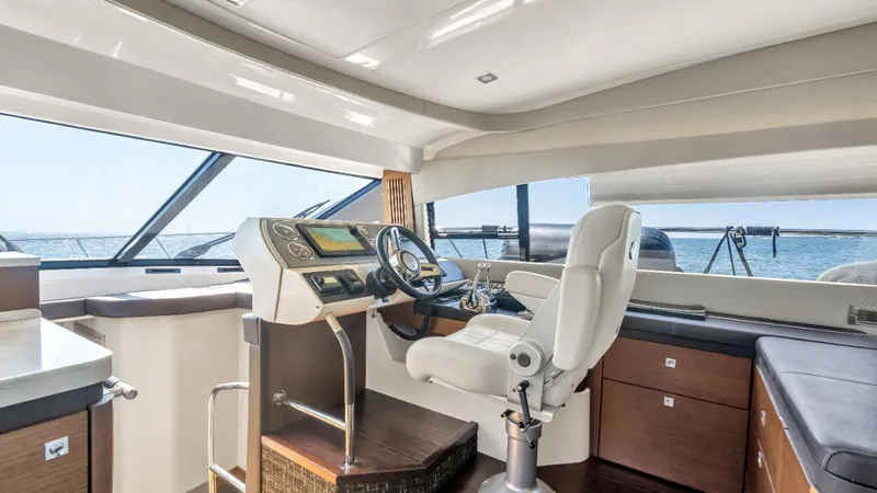 Slide: The Image of 2015 Sea Ray 510 Flybridge interior with modern helm and panoramic windows. - 18