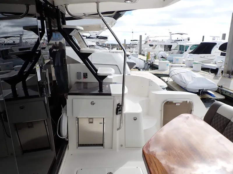 Slide: The Image of 2015 Sea Ray 510 Fly yacht interior with sleek design and modern amenities at a marina. - 22