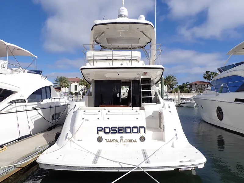 Slide: The Image of 2015 Sea Ray 510 Fly yacht docked, named "Poseidon," in Tampa, Florida marina. - 3