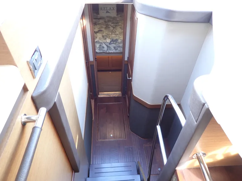 Slide: The Image of Interior staircase of 2015 Sea Ray 510 Fly yacht, featuring sleek wooden design. - 36