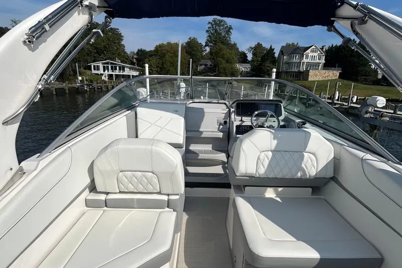 Slide: The Image of 2024 Regal 26 XO boat interior with white seating and modern dashboard. - 10