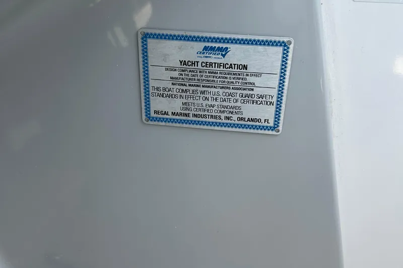 Slide: The Image of 2024 Regal 26 XO yacht certification plaque, compliance with U.S. Coast Guard safety standards. - 14