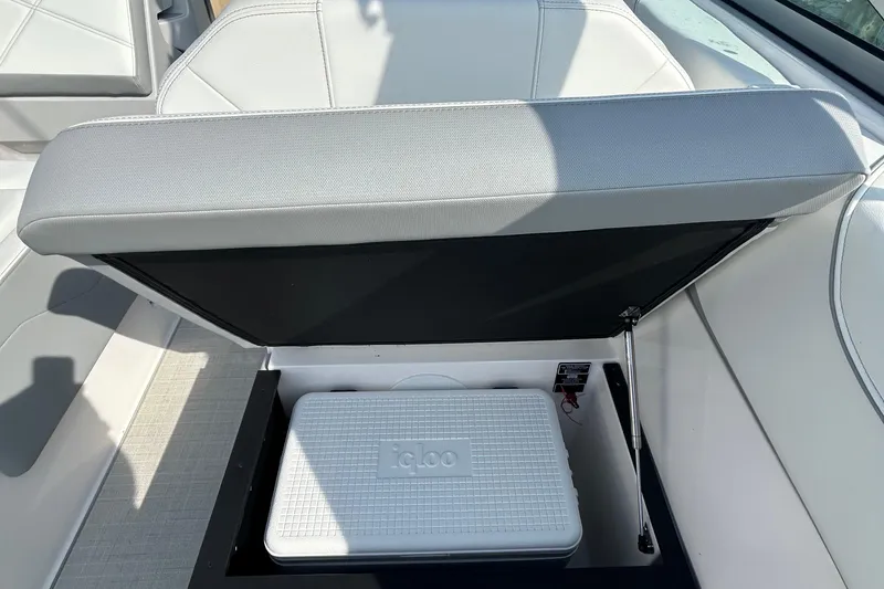 Slide: The Image of 2024 Regal 26 XO boat seat storage with Igloo cooler inside. - 19