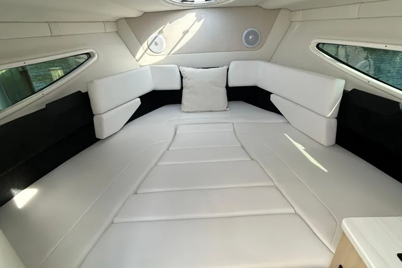 Slide: The Image of 2024 Regal 26 XO cabin interior with white leather seating and modern design. - 21